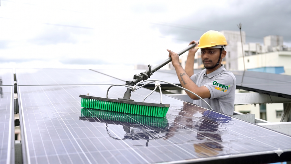 Professional technician cleaning rooftop solar panels for better efficiency.